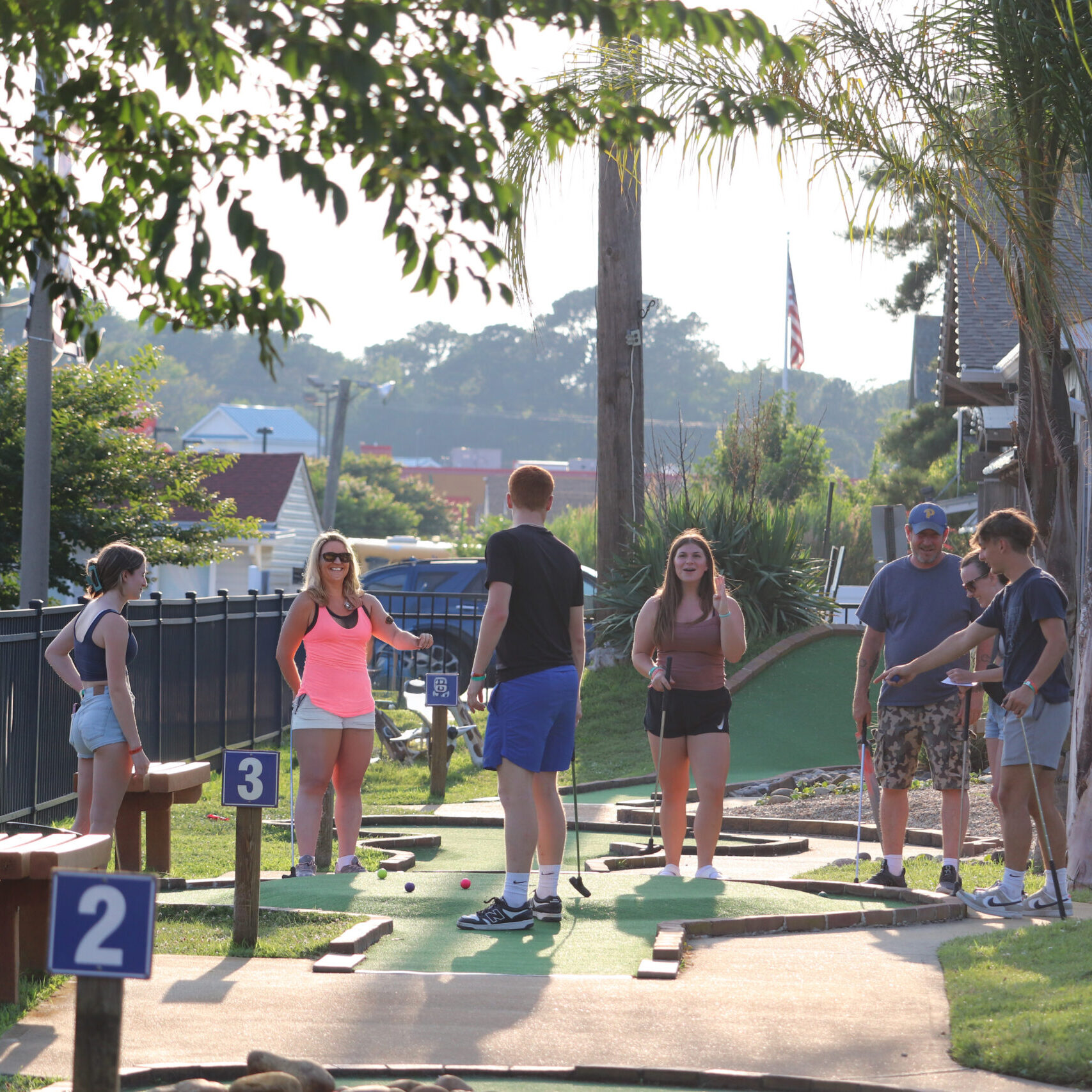 Family playing miniature golf at Baja Amusements: Ocean City Go-Karts.